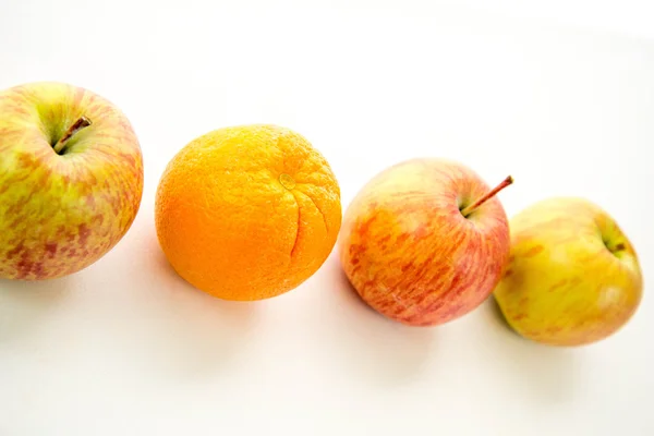 Line of apples with one orange — Stock Photo, Image