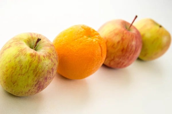 Line of apples with one orange — Stock Photo, Image