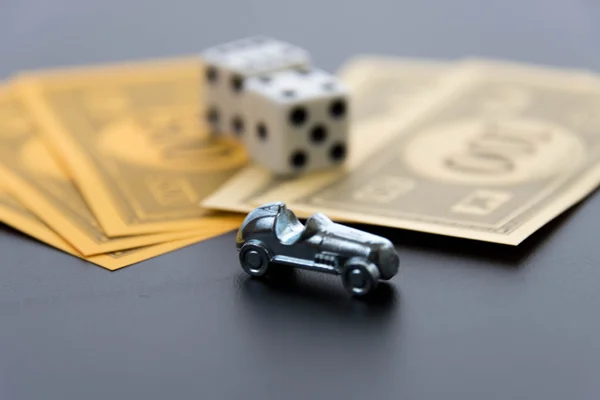 February 8, 2015: Houston, TX, USA.  Monopoly car, dice and mone — Stock Photo, Image