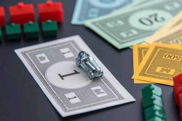 February 8, 2015: Houston, TX, USA.  Monopoly car, money, hotels — Stock Photo, Image