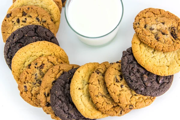 Variety of cookies around a glass of milk — Stock Photo, Image