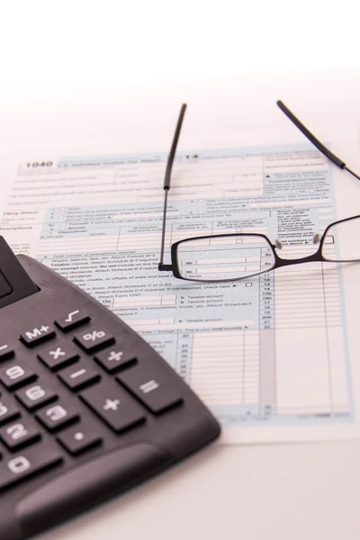 Tax preparation supplies, reading glasses and tax forms — Stock Photo, Image