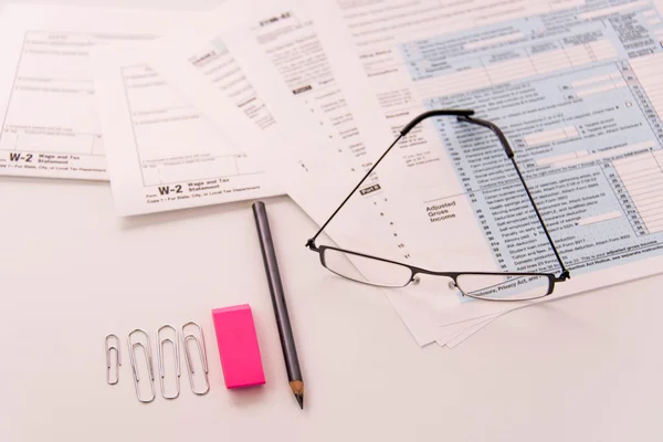 Tax preparation supplies, reading glasses and tax forms — Stock Photo, Image