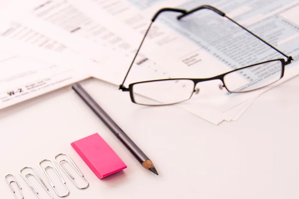 Tax preparation supplies, reading glasses and tax forms — Stock Photo, Image