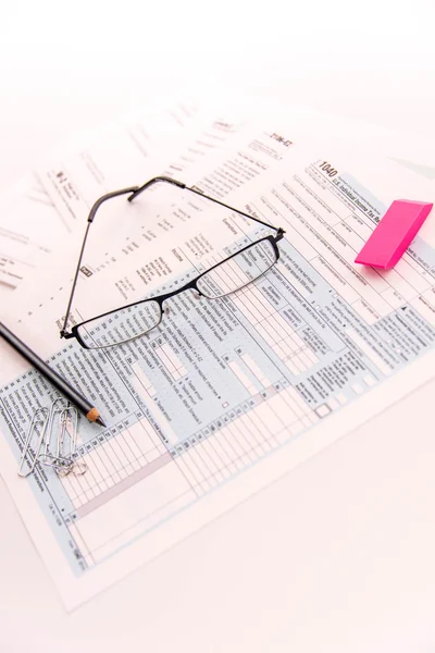 Tax preparation supplies, reading glasses and tax forms