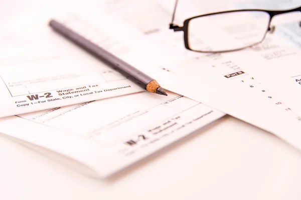 Tax preparation supplies, reading glasses and tax forms