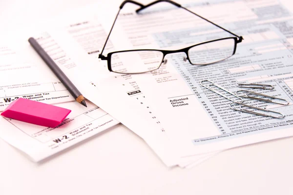 Tax preparation supplies, reading glasses and tax forms — Stock Photo, Image