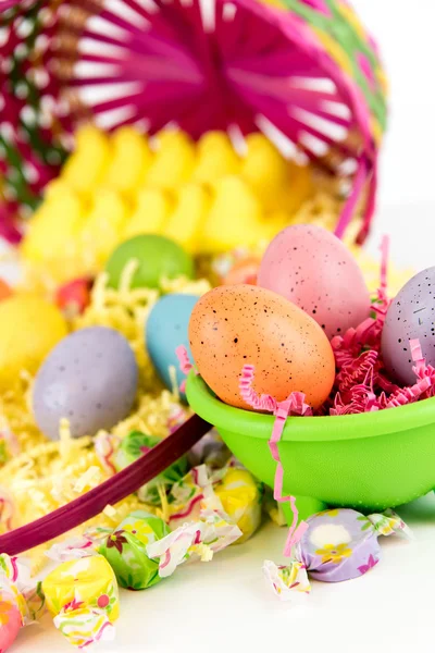 Easter basket with colored eggs, yellow chicks and candy — Stock Photo, Image