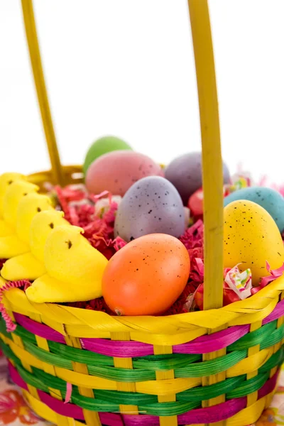 Cesta de Páscoa com ovos coloridos, pintinhos amarelos e doces — Fotografia de Stock