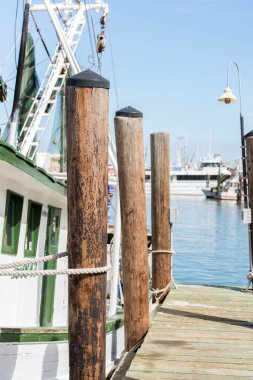 commercial fishing boats at the ocean marina docks clipart