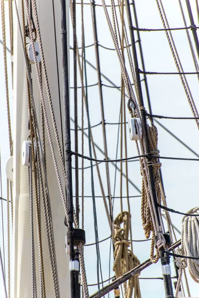 Sailboat masts, rigging and rolled up sails — Stock Photo, Image