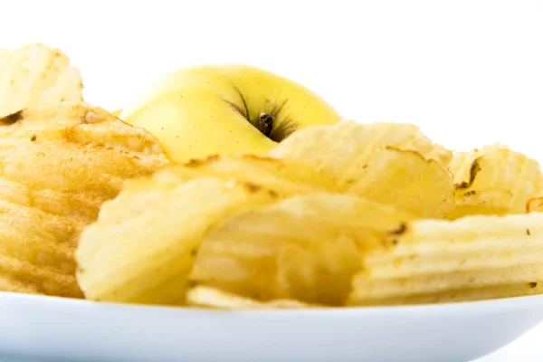 Yellow apple vs yellow salty potato chips — Stock Photo, Image