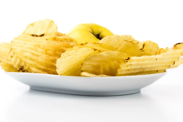 Yellow apple vs yellow salty potato chips — Stock Photo, Image