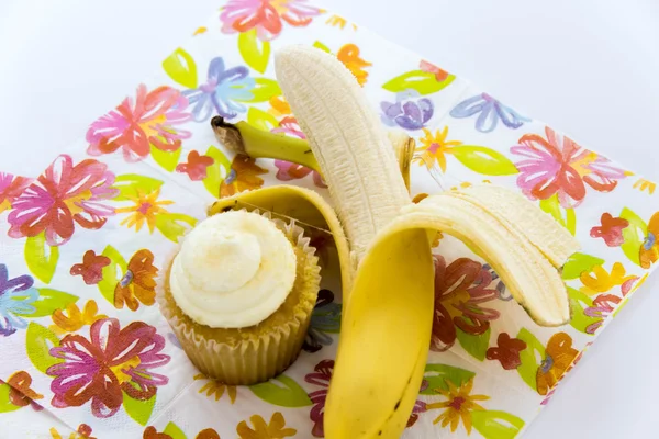 Yellow banana vs yellow cupcake — Stock Photo, Image