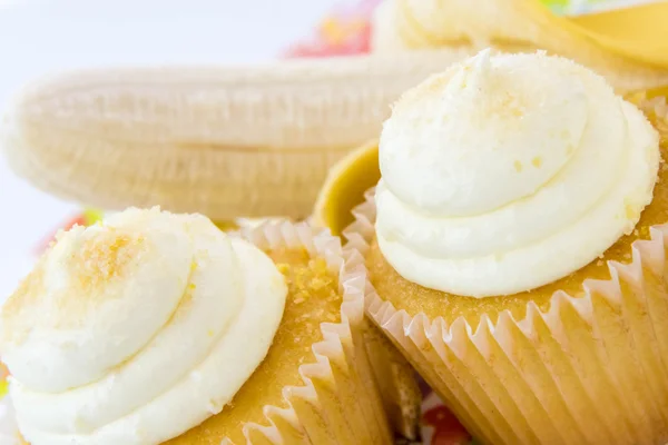 Yellow banana vs yellow cupcake — Stock Photo, Image