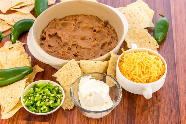 Preparation of bean dip with jalapenos, sour cream and cheddar c — Stock Photo, Image