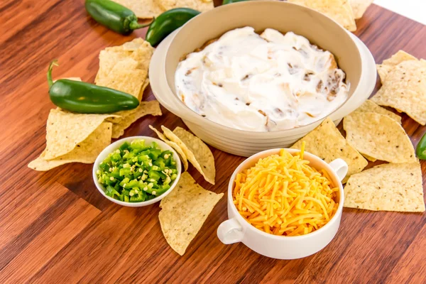 Preparation of bean dip with jalapenos, sour cream and cheddar c — Stock Photo, Image