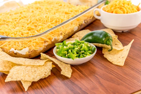 Preparation of bean dip with jalapenos, sour cream and cheddar c — Stock Photo, Image