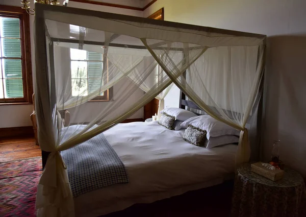 A four poster bed, promising a night of sleeping on feathers