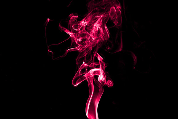 Red smoke isolated with light on back background