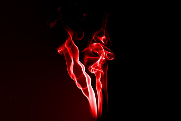 Fire and smoke isolated with light on black background
