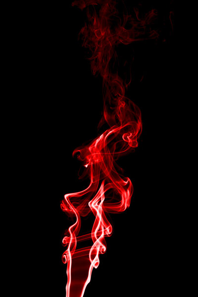 Smoke red on a black background. Shot in studio