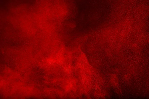 Red powder cloud against dark background Royalty Free Stock Images