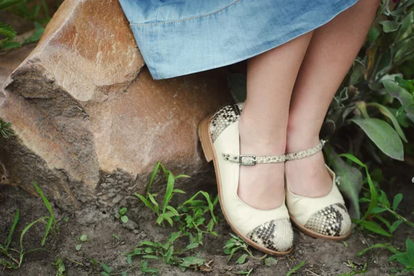 Девушка сидит в красивых новых туфлях — стоковое фото