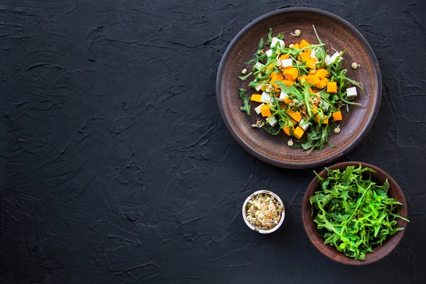 Delicious healthy pumpkin salad with arugula and cheese. Creative atmospheric decoration — Stock Image Delicious Healthy Pumpkin Salad Arugula Cheese Creative Atmospheric Decoration Royalty Free Stock Images