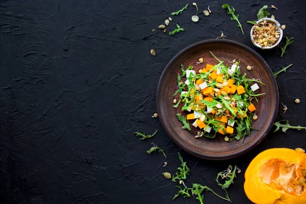 Delicious healthy pumpkin salad with arugula and cheese. Creative atmospheric decoration — Stock Image Delicious Healthy Pumpkin Salad Arugula Cheese Creative Atmospheric Decoration Stock Photo