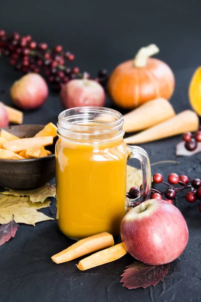 Halloween cocktail, pumpkin orange drink with spices. Dark vintage dirty background. Creative atmospheric decoration