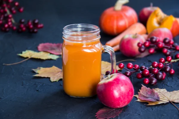 Halloween cocktail, pumpkin orange drink with spices. Dark vintage dirty background. Creative atmospheric decoration