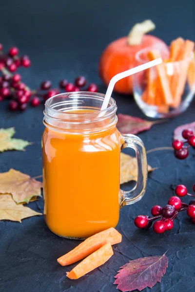 Halloween cocktail, pumpkin orange drink with spices. Dark vintage dirty background. Creative atmospheric decoration