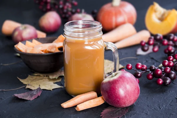 Halloween cocktail, pumpkin orange drink with spices. Dark vintage dirty background. Creative atmospheric decoration