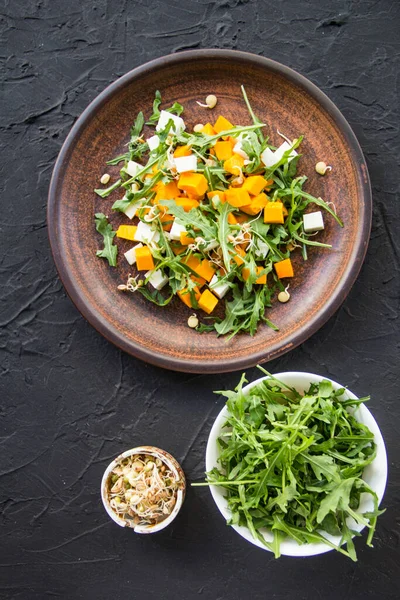 Delicious healthy pumpkin salad with arugula and cheese. Creative atmospheric decoration — Stock Image Delicious Healthy Pumpkin Salad Arugula Cheese Creative Atmospheric Decoration Stock Picture