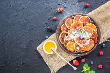 Peynirli krep, böğürtlen ve baldan oluşan sağlıklı bir kahvaltı. Yaratıcı atmosfer dekorasyonu
