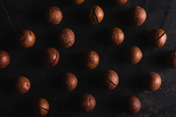 Macadamia nuts on a black background