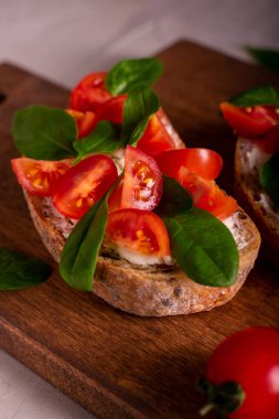 Domatesli, süzme peynirli ve ıspanaklı tam tahıllı sandviç.