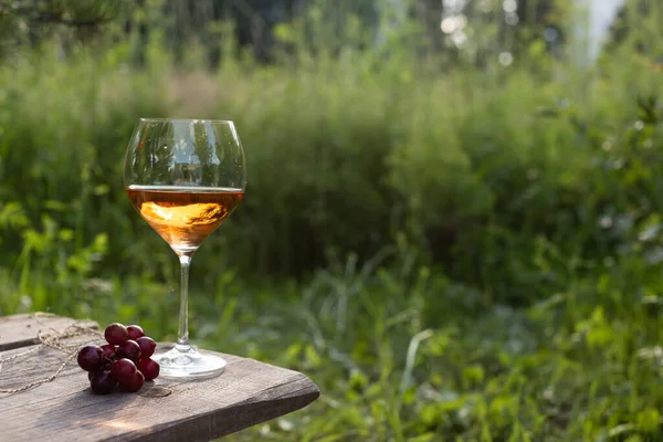 Wine glass on a wooden table in the evening