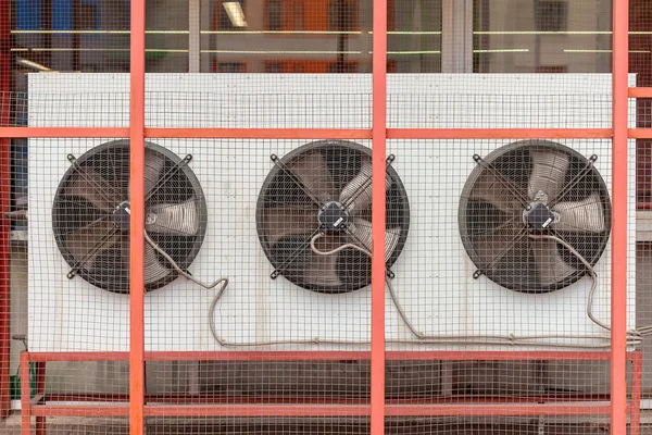 Selective focus of large ventilation system fans in a public building. Metal industrial air conditioning vent. HVAC.