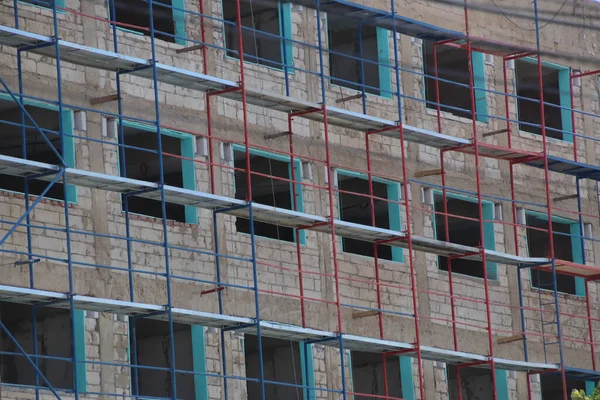 A close up on a building under construction and scaffolding.