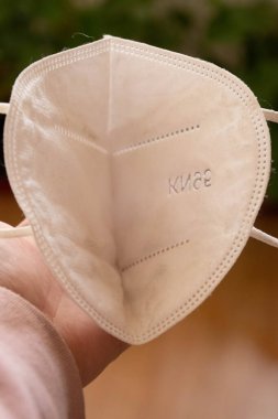 Kirli bir maske takıyor.