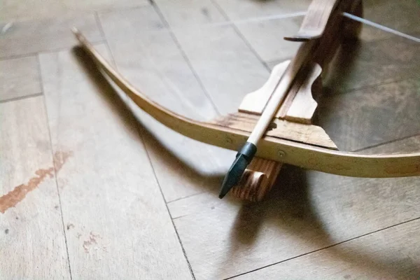 Antique crossbow with a arrow on wood background