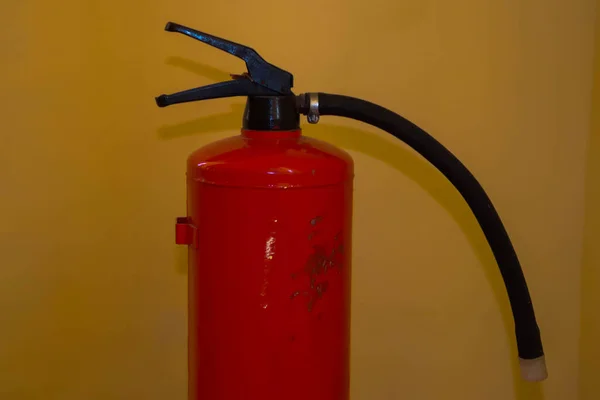 Fire extinguisher close up on a colorful background.