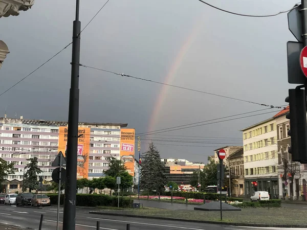 A rainbow in an old downtown from East europe, cloudy day.