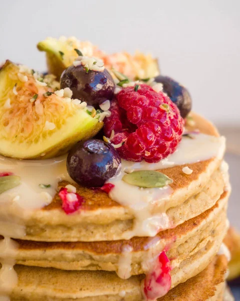 American pancakes made of gluten-free flour, topped with syrup or honey and fruit. Delicious breakfast.
