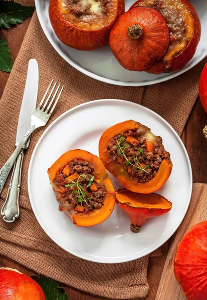 Red kuri squash beef stuffed with vegetables.Red kuri squash  is cultivated variety of the species Cucurbita maxima. It has the appearance of a small pumpkin without the ridges.