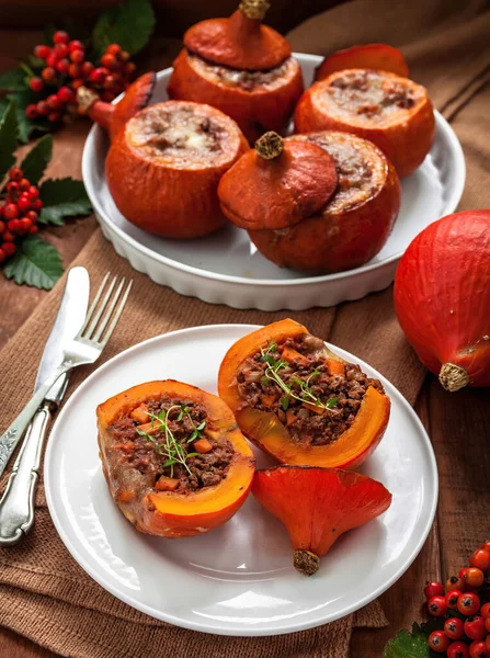 Red kuri squash beef stuffed with vegetables.Red kuri squash  is cultivated variety of the species Cucurbita maxima. It has the appearance of a small pumpkin without the ridges.