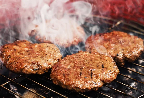 Fast food grilling burgers for sandwiches. A common dish in the USA. Popular dish served from Food Truck.