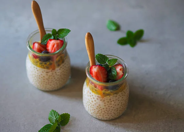 Tapioca pudding with passion fruit, strawberries and blueberries, decorated with mint leaves. Vegan dish. Dietary cuisine. Tapioca as a gluten-free product is recommended for people with celiac disease and intolerance to this protein.